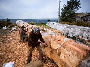 A First Nations artists work on a totem pole in the village of Old Massett, British Columbia, Canada.