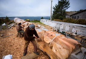 A First Nations artists work on a totem pole in the village of Old Massett, British Columbia, Canada.