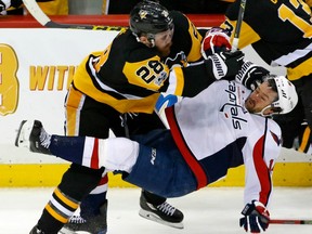 In this May 3 file photo, Pittsburgh Penguins defenceman Ian Cole (left) checks Washington Capitals forward Justin Williams.