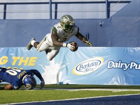 South Florida's D'Earnest Johnson (2) leaps over San Jose State defender Maurice McKnight (10) for a touchdown during the second quarter of an NCAA college football game, Saturday, Aug. 26, 2017, in San Jose, Calif. (AP Photo/D. Ross Cameron)
