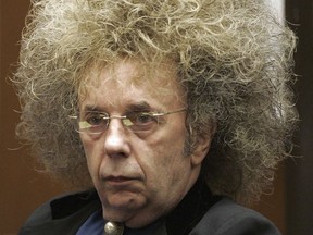 FILE - In this May 23, 2005 file photo music producer Phil Spector appears during his trial at the Los Angeles Superior Court in Los Angeles. A June 14, 2017 mugshot provided by the California Department of Corrections and Rehabilitation shows Spector completely free of the huge hair that was so striking during his murder trial. The 76-year-old music producer is smiling broadly and wearing hearing aids on both ears. He was convicted in 2009 of killing actress Lana Clarkson, and is serving a sentence of 19 years to life. (AP Photo/Damian Dovarganes, File)