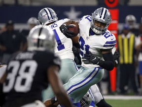 Oakland Raiders cornerback TJ Carrie (38) gives chase as Dallas Cowboys running back Ezekiel Elliott (21) runs the ball through the line of scrimmage in the first half of a preseason NFL football game, Saturday, Aug. 26, 2017, in Arlington, Texas. (AP Photo/Ron Jenkins)