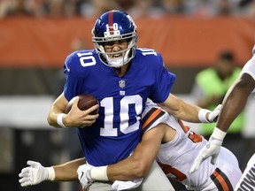 New York Giants quarterback Eli Manning (10) is sacked by Cleveland Browns outside linebacker Joe Schobert (53) in the first half of an NFL preseason football game, Monday, Aug. 21, 2017, in Cleveland. (AP Photo/David Richard)