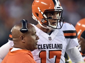 Cleveland Browns coach Hue Jackson, left, talks with quarterback Brock Osweiler during the first half of the team's NFL preseason football game, Thursday, Aug. 10, 2017, in Cleveland. (AP Photo/David Richard)