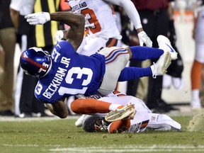 New York Giants wide receiver Odell Beckham (13) is tackled by Cleveland Browns strong safety Briean Boddy-Calhoun (20) in the first half of an NFL preseason football game, Monday, Aug. 21, 2017, in Cleveland. (AP Photo/David Richard)