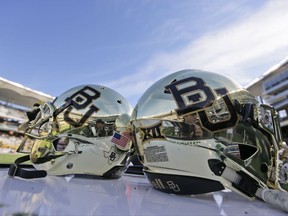 FILE - In this Dec. 5, 2015, file photo, Baylor helmets on shown the field after an NCAA college football game in Waco, Texas. For more than a year, the federal civil lawsuits against Baylor have piled in and piled on, accusing the nation's largest Baptist school of mishandling, ignoring or stifling claims of sexual and physical abuse of students for years. After months of bad publicity, the firing of a popular football coach and demotion and departure of a school president, Baylor is starting to make those cases go away with settlements as evidence gathering is just heating up and well before any of them approach trial. (AP Photo/LM Otero, File)