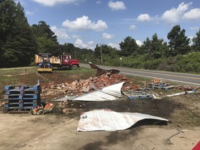 In this Monday, Aug. 21, 2017, photo provided by the Camden News, broken jars of spaghetti sauce litter a road near Camden, Ark. The crash marked the third time this month that edible goods were left on an Arkansas highway. A tanker spilled bourbon on Interstate 40 in eastern Arkansas on Aug. 2, and on Aug. 9 a truck split open on Interstate 30 in Little Rock, spilling frozen pizza. (Shantelle Laughlin/Camden News via AP)