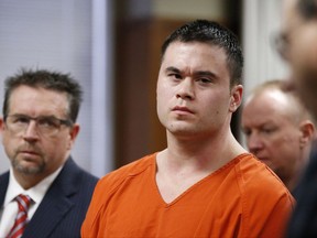 FILE - In this Jan. 21, 2016, file photo, former Oklahoma City police officer Daniel Holtzclaw, center, and his attorney Scott Adams are seen at a sentencing hearing in Oklahoma City. Holtzclaw's conviction and 263-year prison sentence for rape and other sex crimes are coming under increased scrutiny as questions are raised about DNA evidence amid a series of sealed court filings and secret hearings. Holtzclaw is appealing the conviction. (AP Photo/Sue Ogrocki, Pool, File)