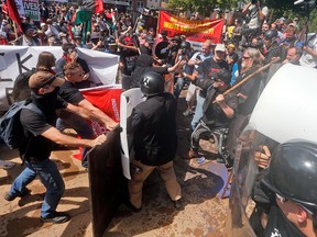White nationalist demonstrators clash with counter protesters at the entrance to Lee Park in Charlottesville, Va., on Aug. 12, 2017.