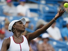 Venus Williams serves to Ashleigh Barty at the Western and Southern Open on Aug. 16.