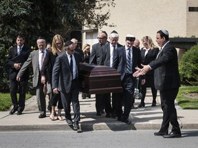 Pallbearers including former Ontario premier Bob Rae (second pallbearer on right) carry the casket of the late Jack Rabinovich in Toronto on Wednesday, August 9, 2017. Scotiabank Giller Prize creator Rabinovitch was celebrated by friends and family members at his funeral on Wednesday, where the beloved businessman was remembered for his warmth, wit and passion for knowledge and the written word. THE CANADIAN PRESS/Christopher Katsarov