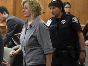 Monica Burke is led out of the courtroom and taken into custody by officers after her sentencing in Boulder, Colo., on Friday, Aug. 25, 2017. The former school bus aide was sentenced to 20 months of prison and 5 years of probation for physically and verbally abusing a disabled student while she worked as a bus assistant for the St. Vrain Valley School District. (Cliff Grassmick/Daily Camera via AP, Pool)