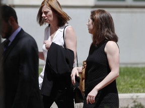 Erica Worden, enter, road manager for pop singer Taylor Swift, is escorted from he federal courthouse after closing arguments were presented in the civil trial involving the singer in a case in federal court Monday, Aug. 14, 2017, in Denver. While the judge has cleared the pop singer, her mother, Andrea, and the singer's radio liaison are still facing allegations that they set out to have a radio host fired for allegedly groping Swift at a photo op before a concert in Denver in 2013. The eight-person jury is expected to decide on that case as well as consider the assault allegation leveled by the singer. (AP Photo/David Zalubowski)