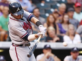 Atlanta Braves' Dansby Swanson connects for a two run double off Colorado Rockies starting pitcher Kyle Freeland during the second inning of a baseball game Tuesday, Aug. 15, 2017, in Denver. (AP Photo/Jack Dempsey)