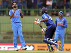 India's Bhuvneshwar Kumar, left, reacts after bowling a delivery to Sri Lanka's Niroshan Dickwella, center, during their second one-day international cricket match in Pallekele, Sri Lanka, Thursday, Aug. 24, 2017. (AP Photo/Eranga Jayawardena)