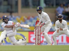 Sri Lanka's Kusal Mendis, left, plays a shot during their second cricket test match against India in Colombo, Sri Lanka, Saturday, Aug. 5, 2017. (AP Photo/Eranga Jayawardena)