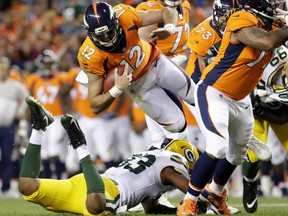 Denver Broncos quarterback Paxton Lynch (12) is upended by Green Bay Packers linebacker Reggie Gilbert (93) during the second half of an NFL preseason football game, Saturday, Aug. 26, 2017, in Denver. (AP Photo/Joe Mahoney)
