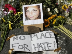 A makeshift memorial of flowers and a photo of victim, Heather Heyer, sits in Charlottesville, Va., Sunday, Aug. 13, 2017. Heyer died when a car rammed into a group of people who were protesting the presence of white supremacists who had gathered in the city for a rally.