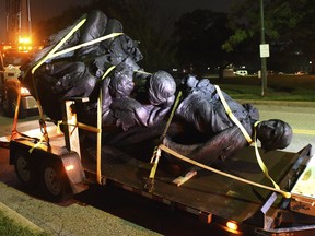 A monument dedicated to the Confederate Women of Maryland lies on a flatbed trailer early Wednesday, Aug. 16, 2017, after it was taken down in Baltimore