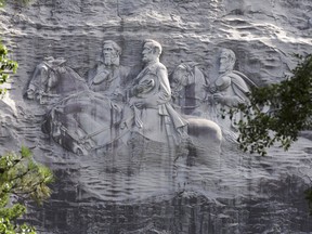 This June 23, 2015 file photo shows the carving depicting Confederate Civil war figures Stonewall Jackson, Robert E. Lee and Jefferson Davis, in Stone Mountain, Ga.