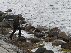 A police officer attends the south coast of the isle of Amager, near Copenhagen, Denmark, Monday Aug. 21, 2017. The body of a woman has been found in the Baltic Sea near where a missing Swedish journalist is believed to have died on a privately built submarine, police in Denmark said late Monday. (Kenneth Meyer/Ritzau Foto via AP)