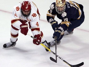 Denver's Will Butcher, left, and Notre Dame's Mike O' Leary vie for the puck during the first period of an NCAA Frozen Four men's college hockey semifinal, Thursday, April 6, 2017, in Chicago. College hockey's top player is an NHL free agent after former University of Denver defenceman Will Butcher allowed a deadline to pass without signing with the Colorado Avalanche.THE CANADIAN PRESS/AP/Nam Y. Huh