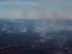 Smoke from wildfires fills the air and burned trees are seen in this aerial view from a Canadian Forces Chinook helicopter near Williams Lake.