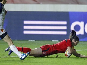 Canada's Elissa Alarie scores the first try for her team, during the semi final match of the Women's Rugby World Cup 2014 between France and Canada in Paris, Wednesday, Aug. 13, 2014. THE CANADIAN PRESS/AP-Remy de la Mauviniere