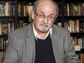 Author Salman Rushdie signs a copy of his new book 'Home' at a book signing in London, Tuesday, June 6, 2017. As Donald Trump continues to face backlash for blaming "both sides" for deadly violence in Charlottesville, Va., celebrated author Rushdie says he's not surprised by the behaviour exhibited by the embattled U.S. president.THE CANADIAN PRESS/AP-Photo by Grant Pollard/Invision/AP