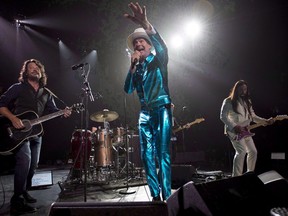 Tragically Hip frontman Gord Downie, centre, leads the band through a concert in Vancouver, Sunday, July 24, 2016. A new biography on the Tragically Hip and band frontman Gord Downie will be published in 2018. THE CANADIAN PRESS/Jonathan Hayward