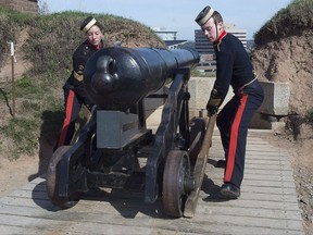 Sgt. Brittany Avery, left, and Regimental Sgt. Maj. Craig Hyatt, dressed as the 3rd Brigade Royal Artillery of 1869, maneuver the noon gun at the Halifax Citadel National Historic Site in Halifax on Friday, Oct. 7, 2016. In Canada's it's not just about building it so they will come, it appears making it free also plays a role.More than 14 million people streamed through the gates of national parks and historic sites between January 1 and July 31, up 12 per cent over the year before. THE CANADIAN PRESS/Andrew Vaughan