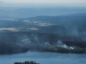 Wildfires are seen from a Canadian Forces Chinook helicopter as Prime Minister Justin Trudeau views areas affected by wildfire near Williams Lake, B.C., on Monday, July 31, 2017. British Columbia has extended a provincewide state of emergency because of wildfires that have scorched a record amount of land this season. THE CANADIAN PRESS/Darryl Dyck