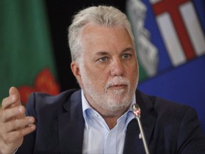 Quebec Premier Philippe Couillard speaks during the final press conference at the Council of Federation meetings in Edmonton Alta, on Wednesday July 19, 2017. Quebec Premier Philippe Couillard says a line has been crossed with the torching of a mosque president's car and that citizens need to come together and clearly take a stand against hate. THE CANADIAN PRESS/Jason Franson
