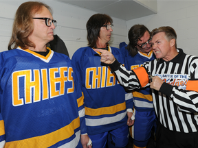 In this Sept. 26, 2011 file photo, the "Hanson Brothers" — from left, Dave Hanson, Steve Carlson and Geoff Carlson — are shown with former NHL referee Kerry Fraser.