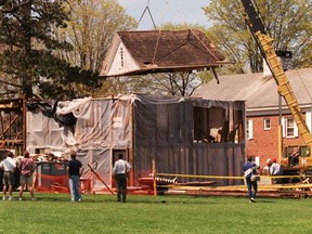 In this April 22, 1998 photo, the attic study of the home of the late Lyman Beecher is lifted off of its colonial post and beam foundation on the Foreman School campus in Litchfield, Conn. Taken apart and stored in pieces, the house where Harriet Beecher Stowe grew up is for sale on eBay, with an asking price of $400,000. Museums passed on the building, and the owner went to the online auction site after finding no takers on Craigslist. (Patrick Raycraft/The Courant via AP)