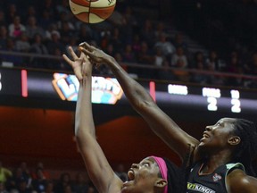 Connecticut Sun's Jonquel Jones shoots in front of New York Liberty's Tina Charles, during a WNBA basketball game in Uncasville, Conn., Friday, Aug. 18, 2017. (John Shishmanian/The Norwich Bulletin via AP)