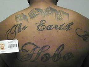 FILE - This undated file photo in a court filing provided by the United States Attorney's office in Chicago, shows Paris Poe's back tattoo that reads "The Earth Is Our Turf", and "Hobo." A federal judge has sentenced Poe, a hit man with a Chicago street gang to life in prison in one of the city's largest gang cases in years on Friday, Aug. 11, 2017. U.S. District Judge John Tharp judge noted that Poe killed two government witnesses planning to testify against his gang, the Hobos. (United States Attorney's office in Chicago via AP, File)