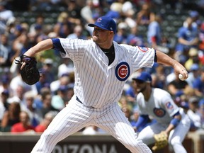 Chicago Cubs starting pitcher Jon Lester (34) throws against the Cincinnati Reds during the first inning of a baseball game, Thursday, Aug. 17, 2017, in Chicago. (AP Photo/David Banks)