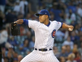 Chicago Cubs starting pitcher Jose Quintana winds up during the first inning of the team's baseball game against the Pittsburgh Pirates on Wednesday, Aug. 30, 2017, in Chicago. (AP Photo/Charles Rex Arbogast)