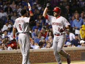Cincinnati Reds' Zack Cozart, right, celebrates his two-run home run off Chicago Cubs relief pitcher Hector Rondon with Billy Hamilton during the seventh inning of a baseball game Wednesday, Aug. 16, 2017, in Chicago. (AP Photo/Charles Rex Arbogast)