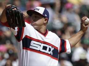Chicago White Sox starting pitcher Derek Holland throws against the Kansas City Royals during the first inning of a baseball game, Sunday, Aug. 13, 2017, in Chicago. (AP Photo/Nam Y. Huh)