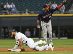 Chicago White Sox's Yoan Moncada (10) arrives at second with a double as Minnesota Twins shortstop Jorge Polanco (11) catches the throw during the first inning of a baseball game in Chicago on Tuesday, Aug. 22, 2017. (AP Photo/Matt Marton)