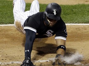 Chicago White Sox's Yoan Moncada scores against the Minnesota Twins during the fourth inning of a baseball game Thursday, Aug. 24, 2017, in Chicago. (AP Photo/Nam Y. Huh)