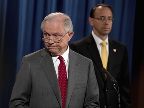 Deputy Attorney General Rod Rosenstein watches at right as Attorney General Jeff Sessions steps away from the podium during a news conference at the Justice Department in Washington, Friday, Aug. 4, 2017, on leaks of classified material threatening national security. (AP Andrew Harnik)