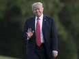 President Donald Trump waves as he walks from Marine One across the South Lawn of the White House in Washington, Wednesday, Aug. 23, 2017, as he returns from Reno, Nev.