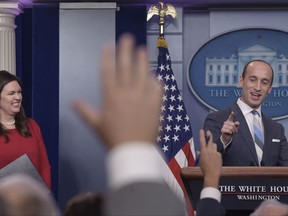 White House press secretary Sarah Huckabee Sanders, left, watches as White House senior policy adviser Stephen Miller calls on a reporter during the daily briefing at the White House in Washington, Wednesday, Aug. 2, 2017. (AP Photo/Susan Walsh)