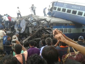 Railway police and local volunteers look for survivors in the upturned coaches of the Kalinga-Utkal Express after an accident near Khatauli, in the northern Indian state of Uttar Pradesh, Saturday, Aug. 19, 2017. Six coaches of a passenger train derailed in northern India on Saturday, killing more than 20 people and injuring dozens, officials said. (AP Photo)