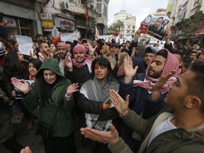 FILE -- In this March 13, 2017 file photo, protesters rally at an anti -government demonstration calling for Palestinian President Mahmoud Abbas to resign and an end to security cooperation with Israel, in the West Bank city of Ramallah. Abbas has clamped down on social media and news websites with a vaguely worded decree that critics say allows his government to jail anyone deemed to harm "public unity" or the "safety of the state." Digital media have become the main outlets for debate and dissent in the Abbas-ruled enclaves of the Israeli-occupied West Bank. (AP Photo/Majdi Mohammed, File)