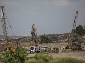 In this Sept. 8, 2016 file photo, heavy machinery works on a massive underground barrier.