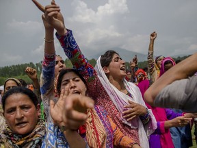 Kashmiri village women shout pro-Pakistani and pro-freedom slogans during the funeral procession of senior militant Arif Nabi Dar in Lilhar, about 35 kilometers (22 miles) south of Srinagar, Indian controlled Kashmir, Tuesday, Aug. 1, 2017. Large anti-India protests and clashes spearheaded mostly by students erupted in disputed Kashmir on Tuesday after government forces killed two senior militants in a gunbattle and fatally shot a protester during an ensuing demonstration demanding an end to Indian rule. (AP Photo/Dar Yasin)